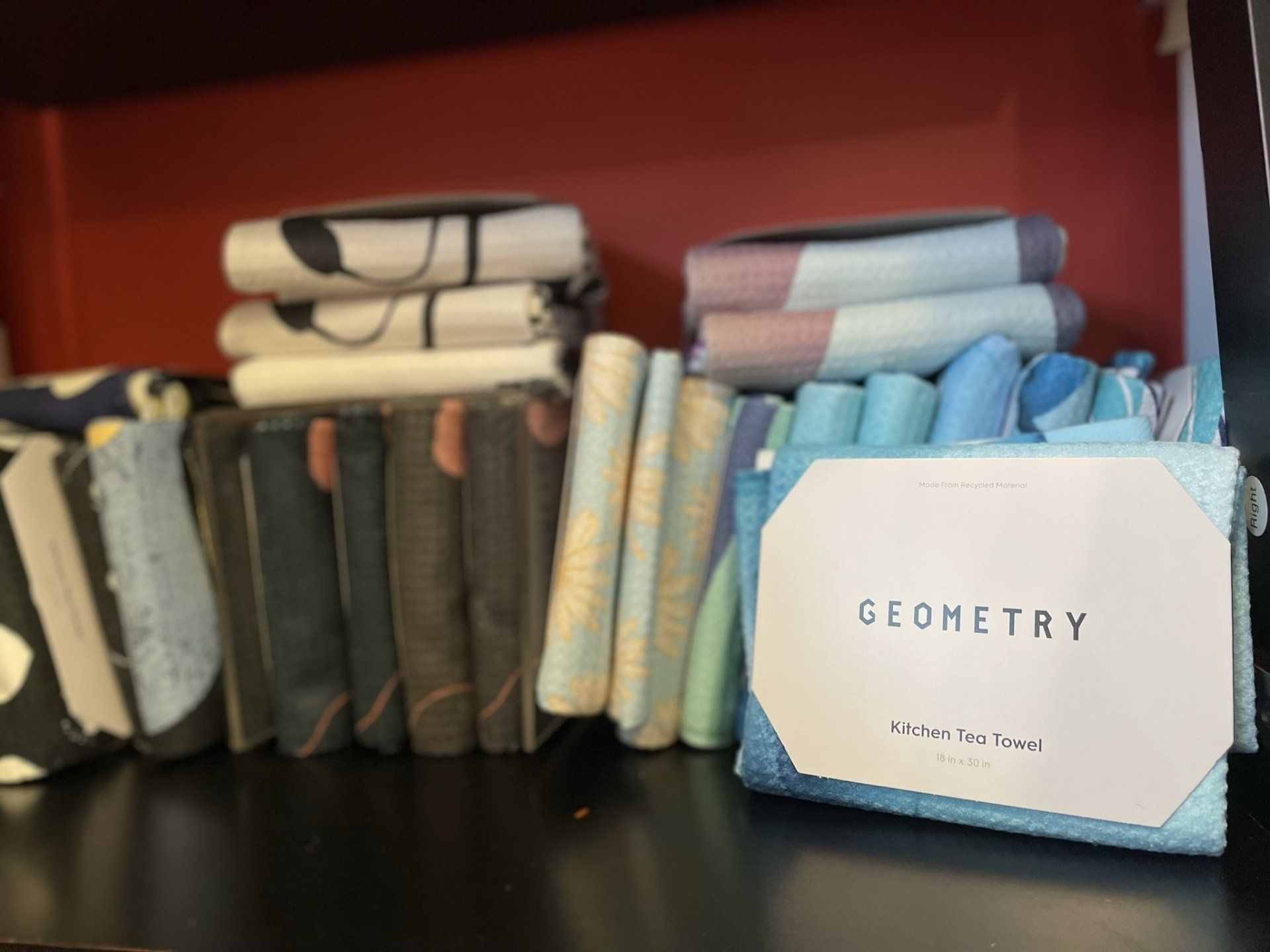 A box of geometry sits on a shelf next to a stack of books