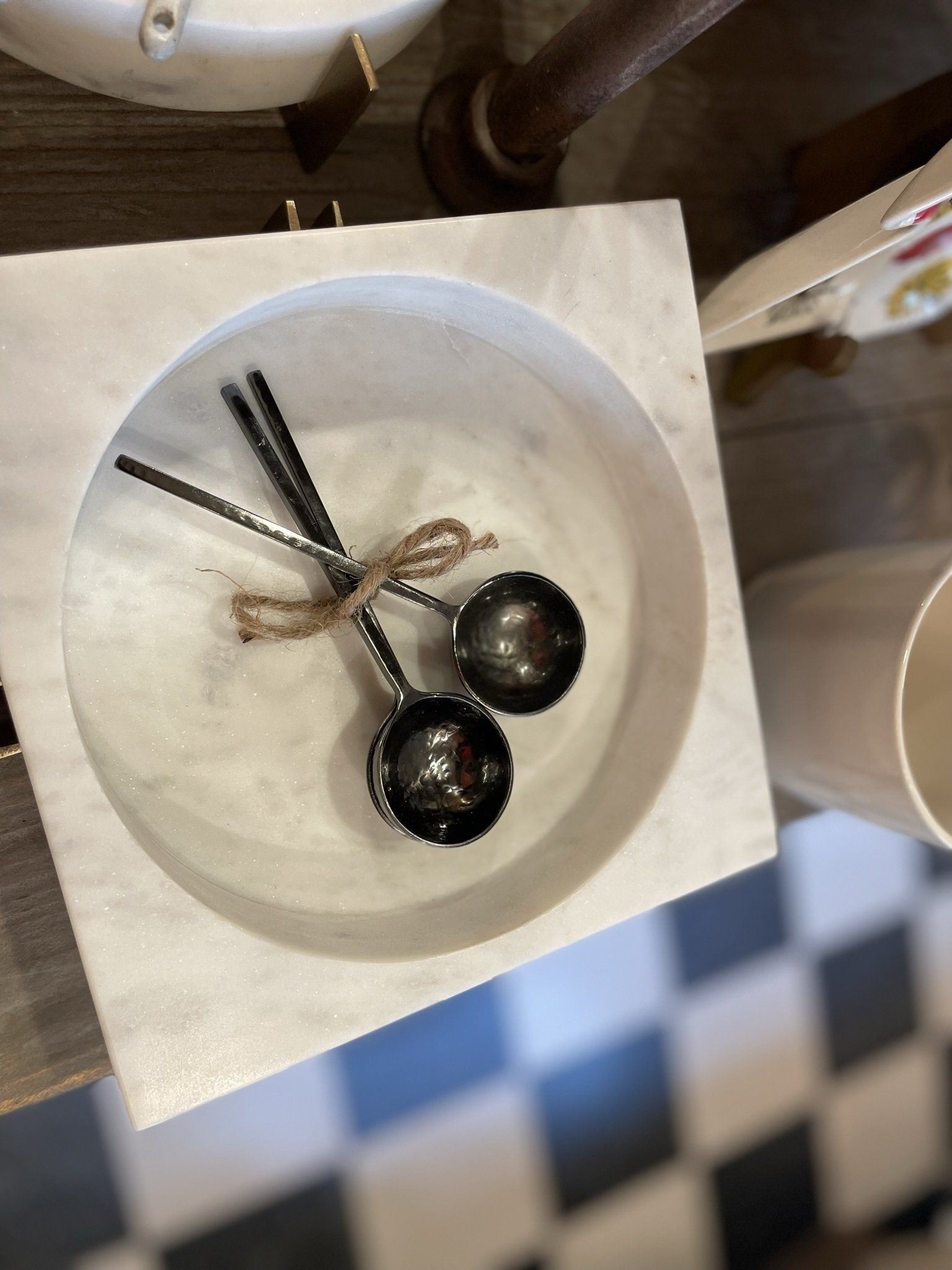 A bowl with two measuring spoons in it