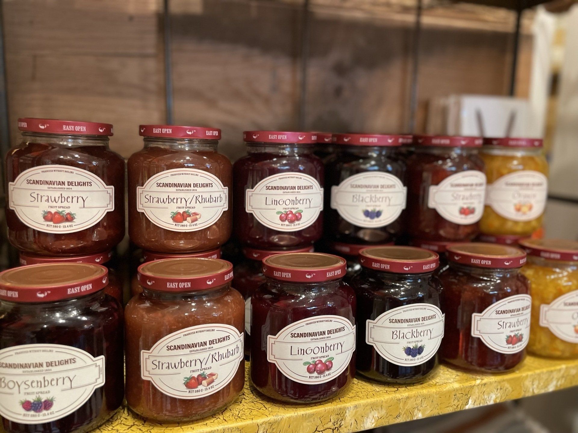 A shelf filled with jars of jam and jelly.