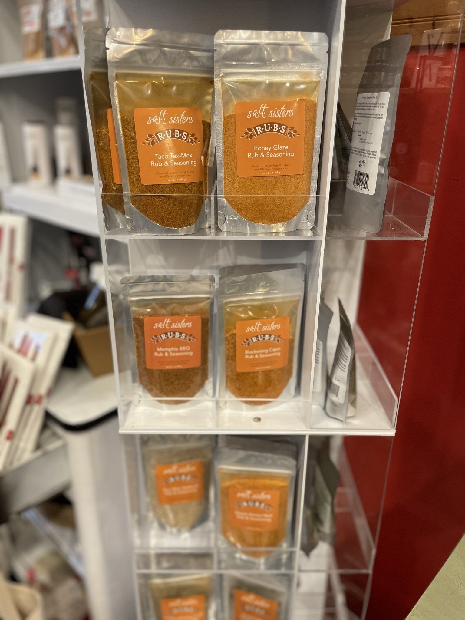 A display of spices on a shelf in a store.