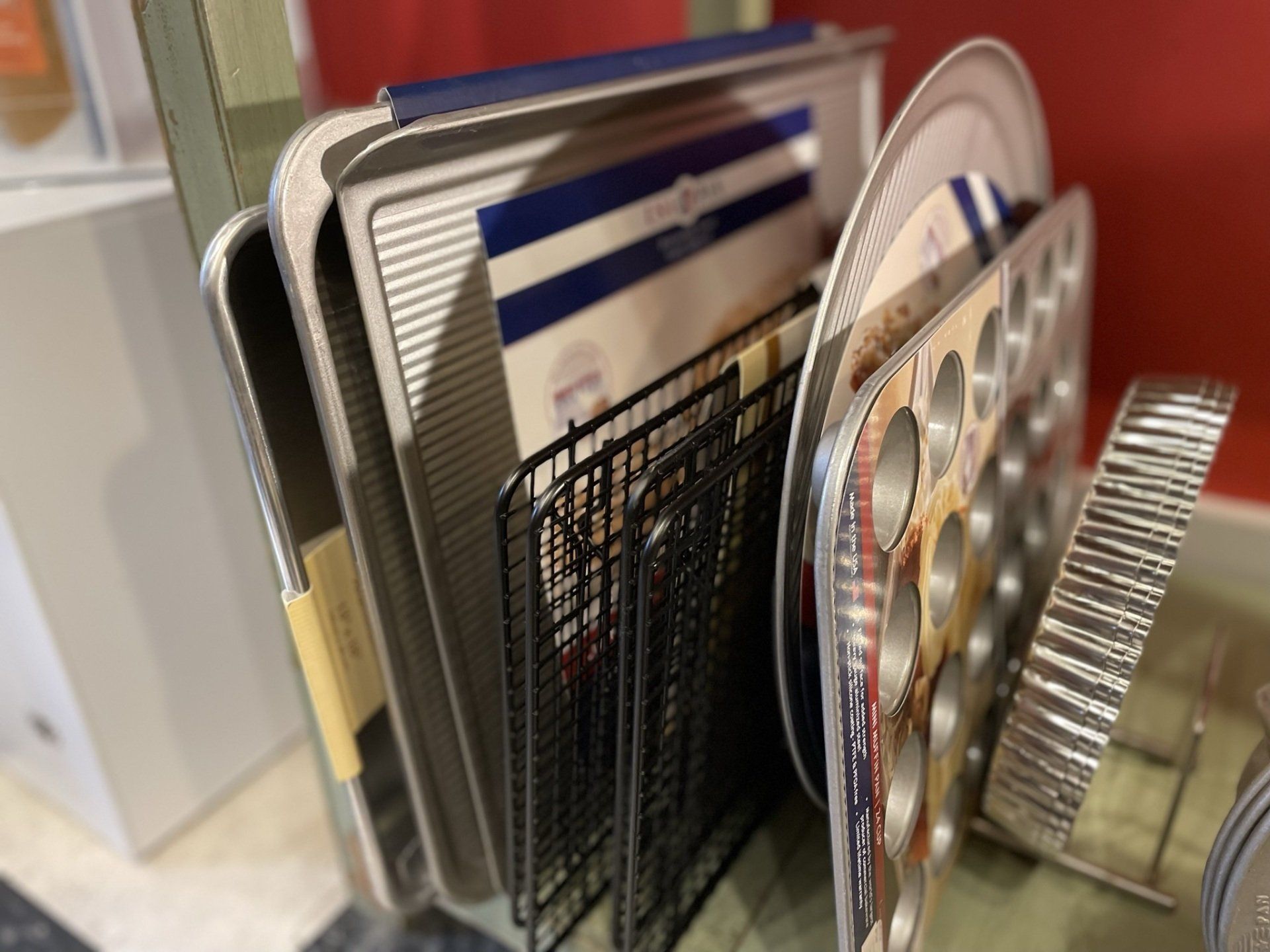 A bunch of pans are stacked on top of each other on a rack