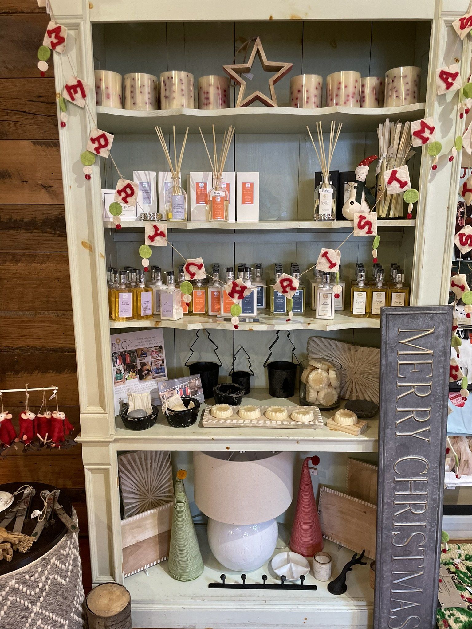 A shelf with a sign that says merry christmas on it
