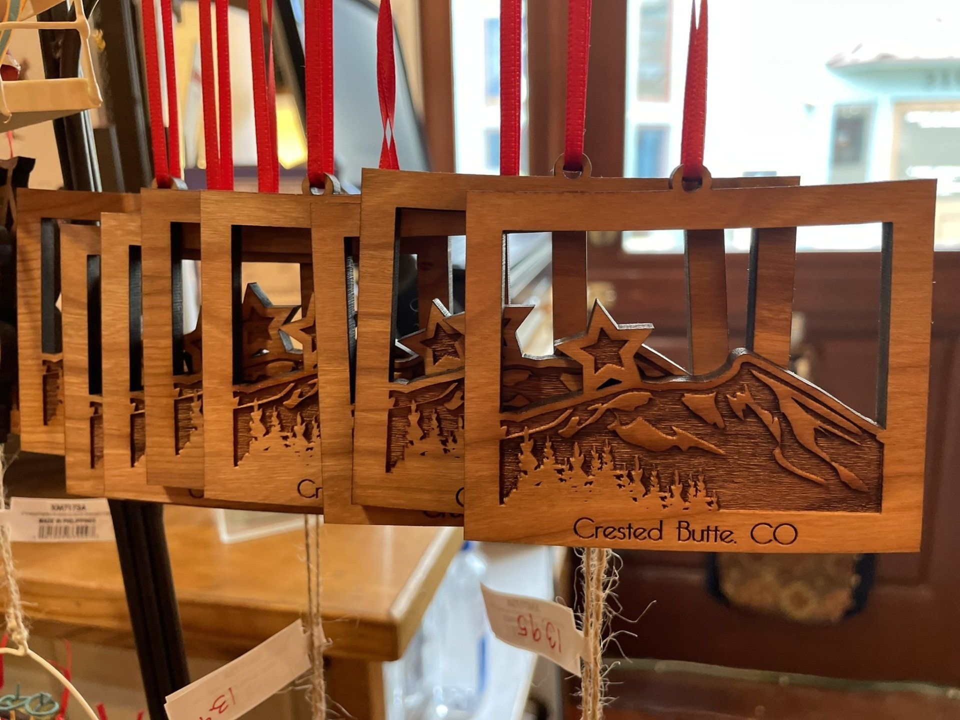 A row of wooden christmas ornaments are sitting on a table.