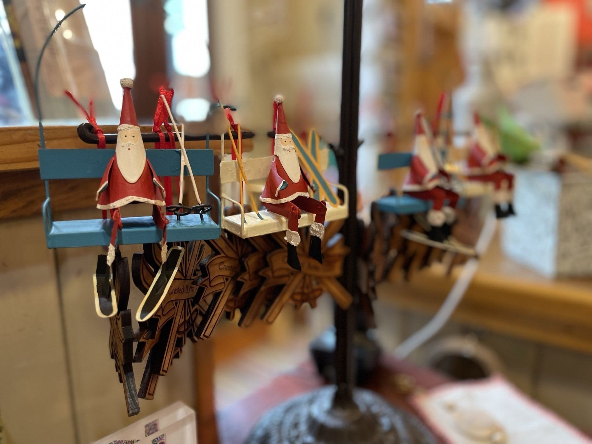 A display of christmas ornaments with santa clauses on skis