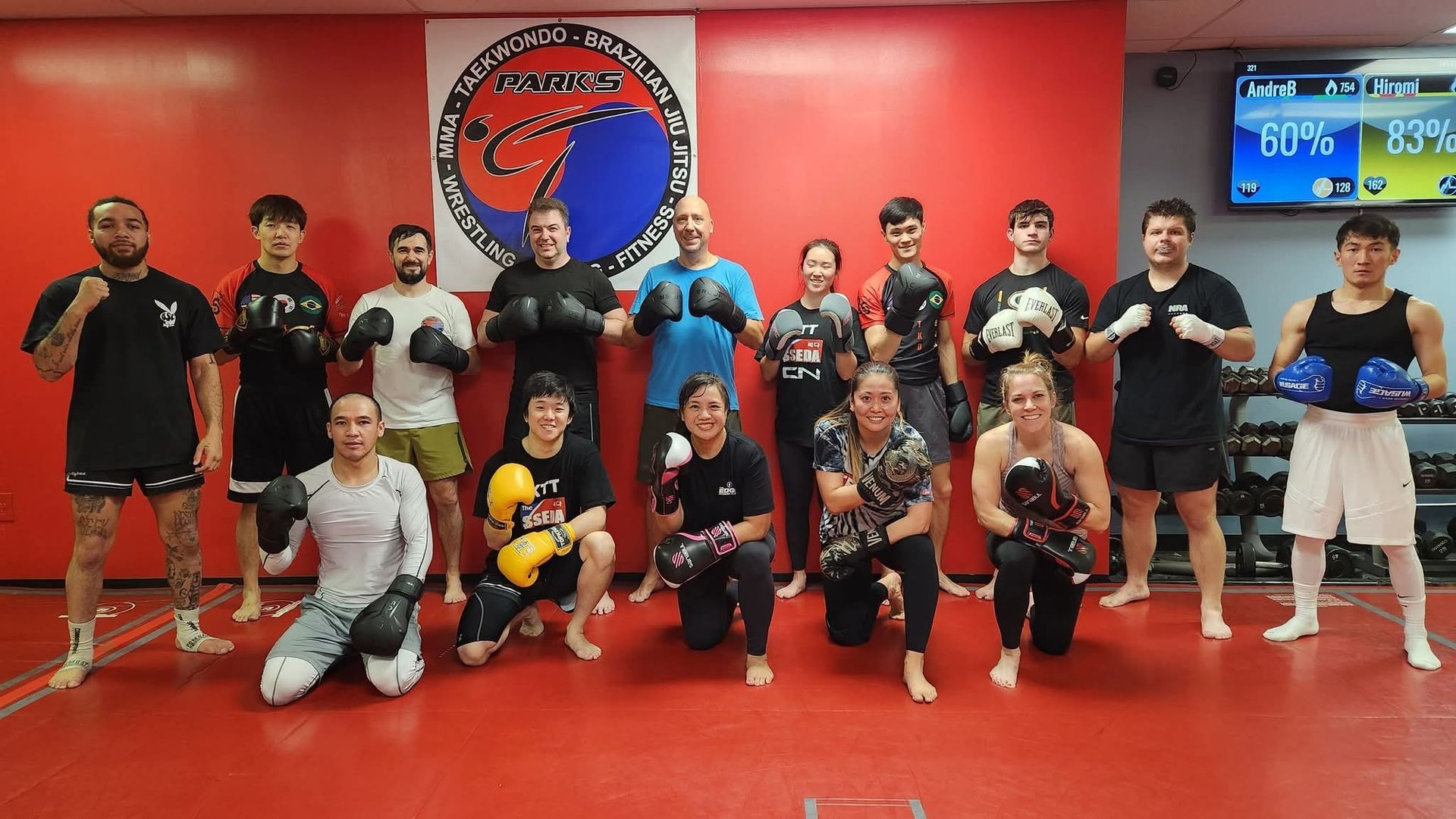 A group of people are posing for a picture in a gym.