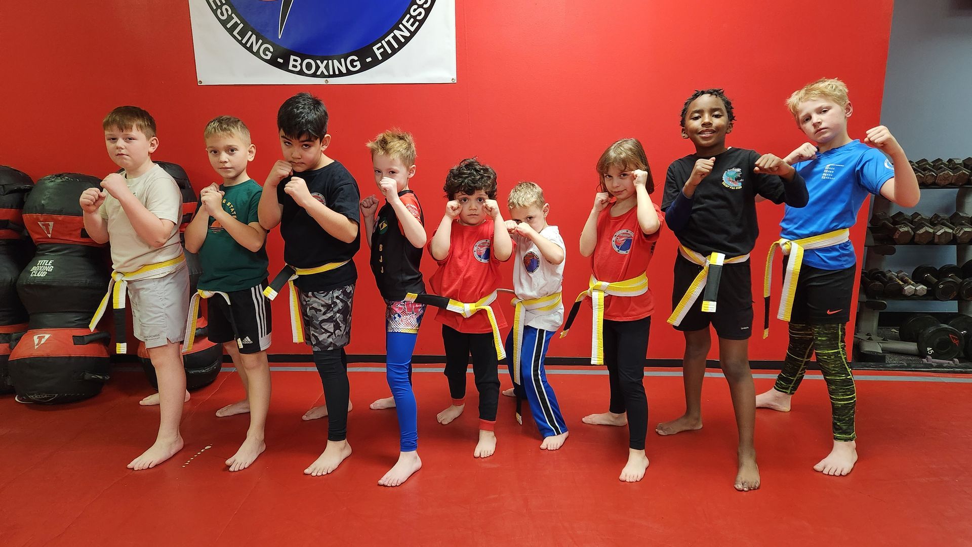A group of young boys are posing for a picture in a gym.