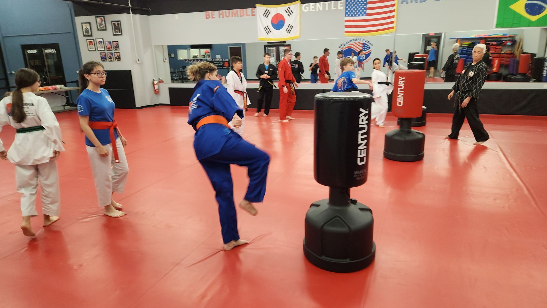 A group of people are practicing martial arts in a gym.