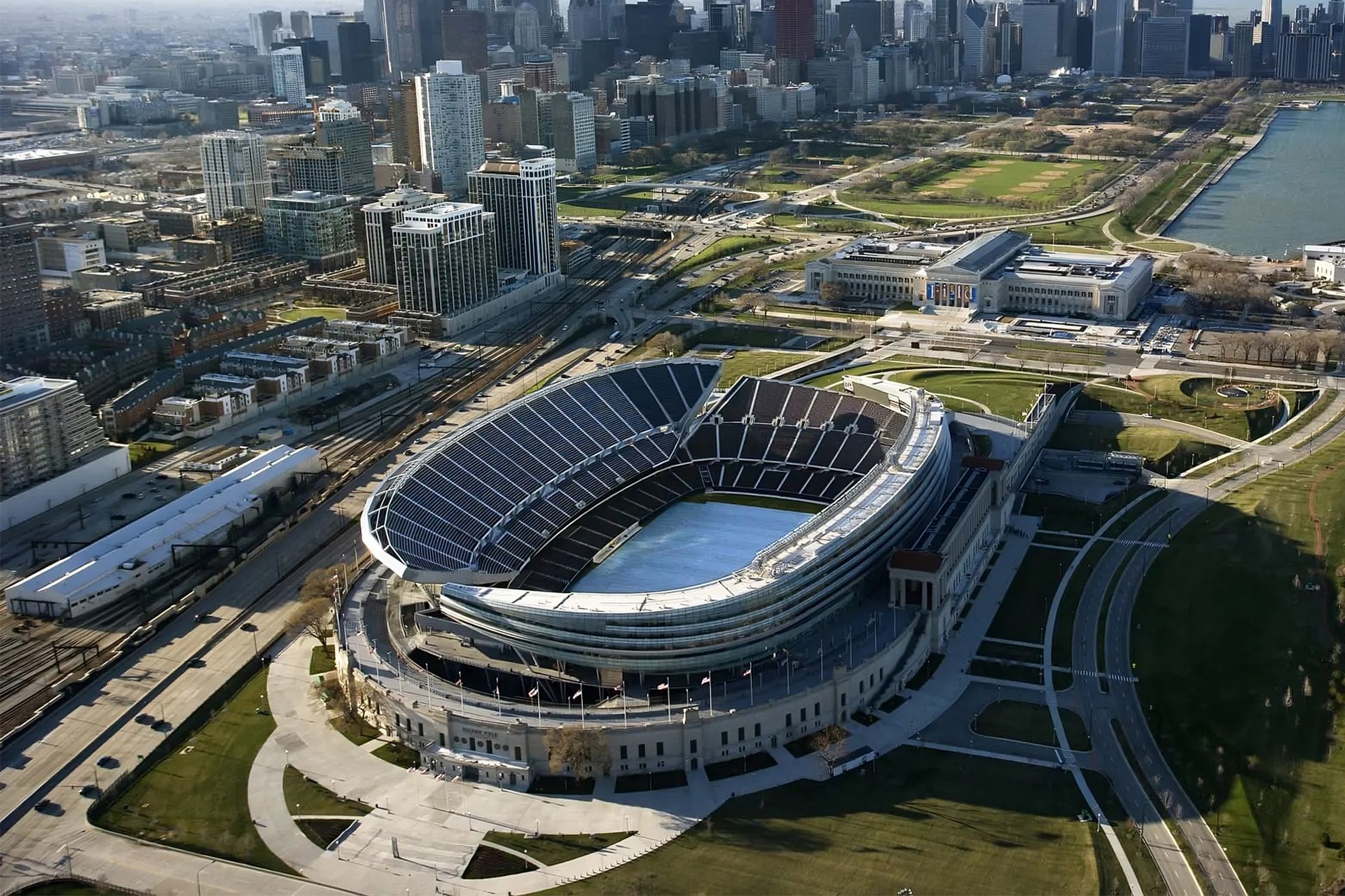 Aerial view of Soldier Field stadium in Chicago, IL, with the city skyline and Lake Michigan in the background