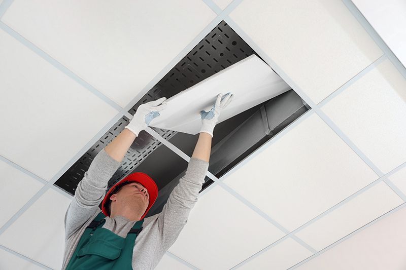 Worker Installing Ceiling Tiles