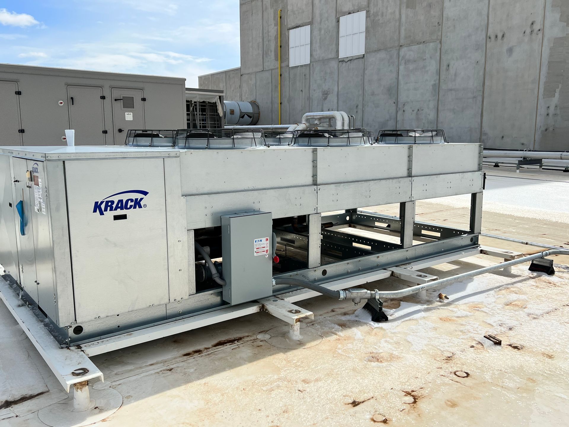 A kraack air conditioner is sitting on top of a roof.