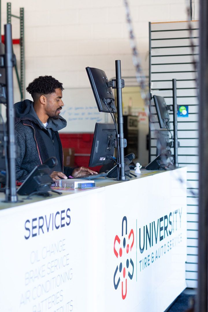 Man Working at a Service Counter | University Tire & Auto Service