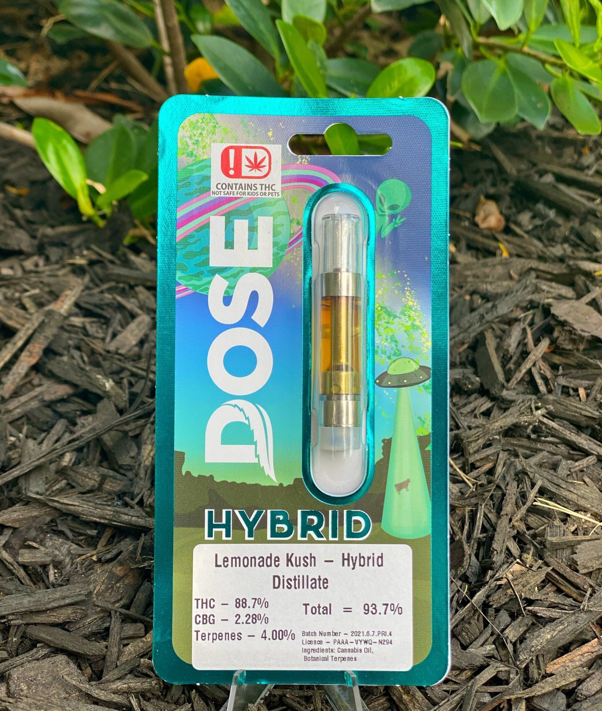 A dose hybrid cartridge is sitting on top of a pile of mulch.