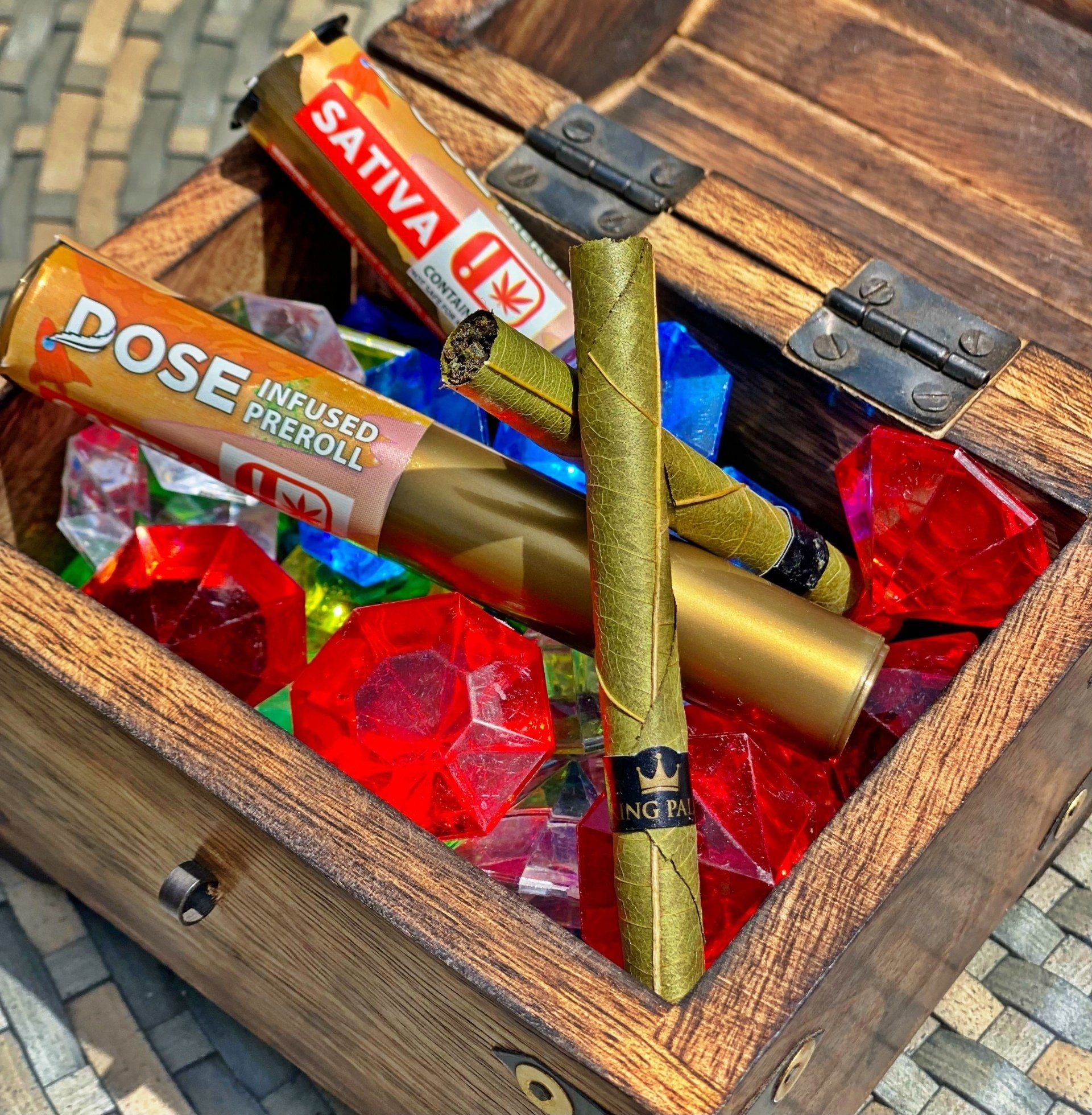 A wooden box filled with a variety of tobacco products