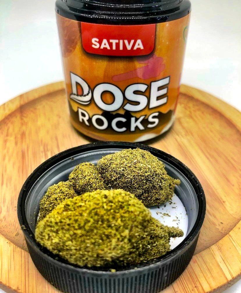 A jar of dose rocks next to a bowl of rocks