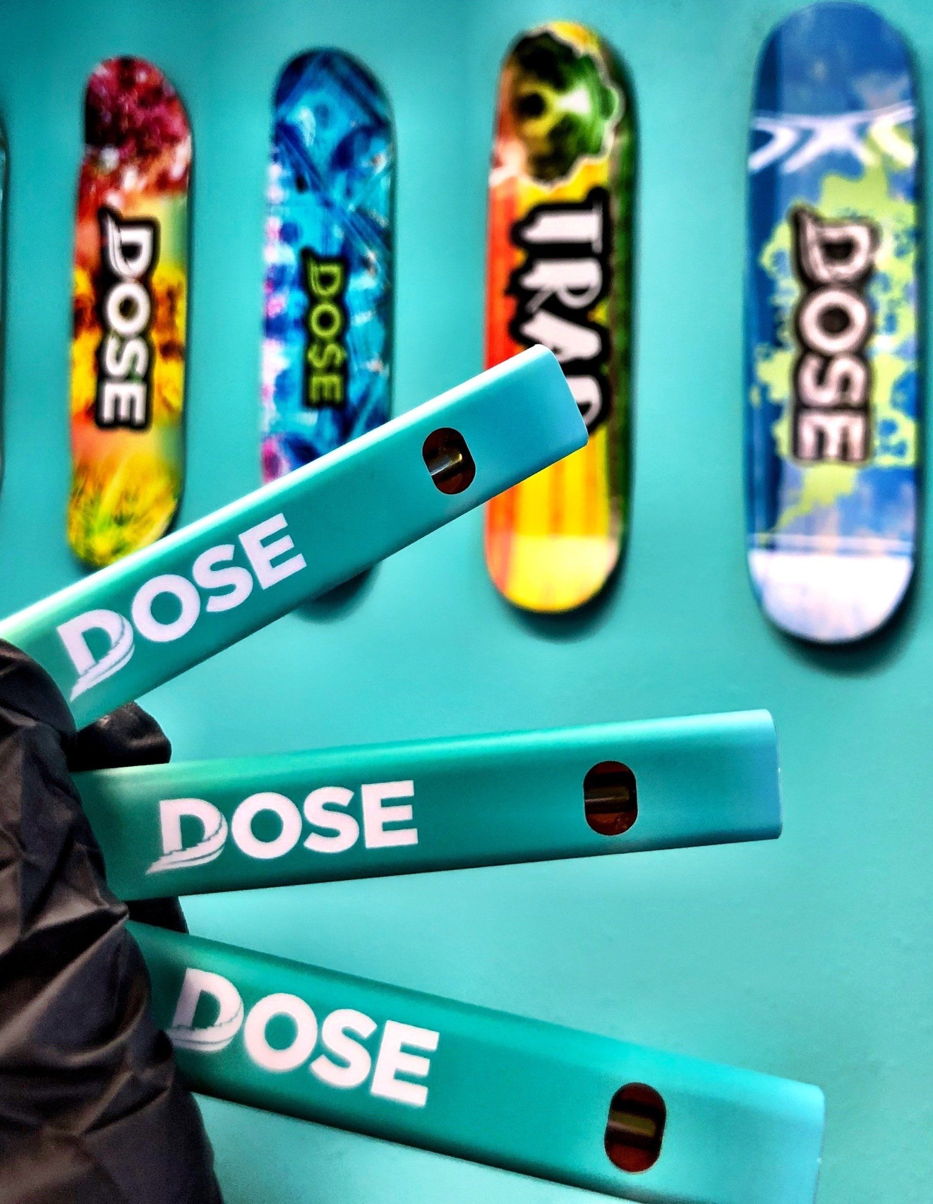 A row of skateboards with the word dose on them