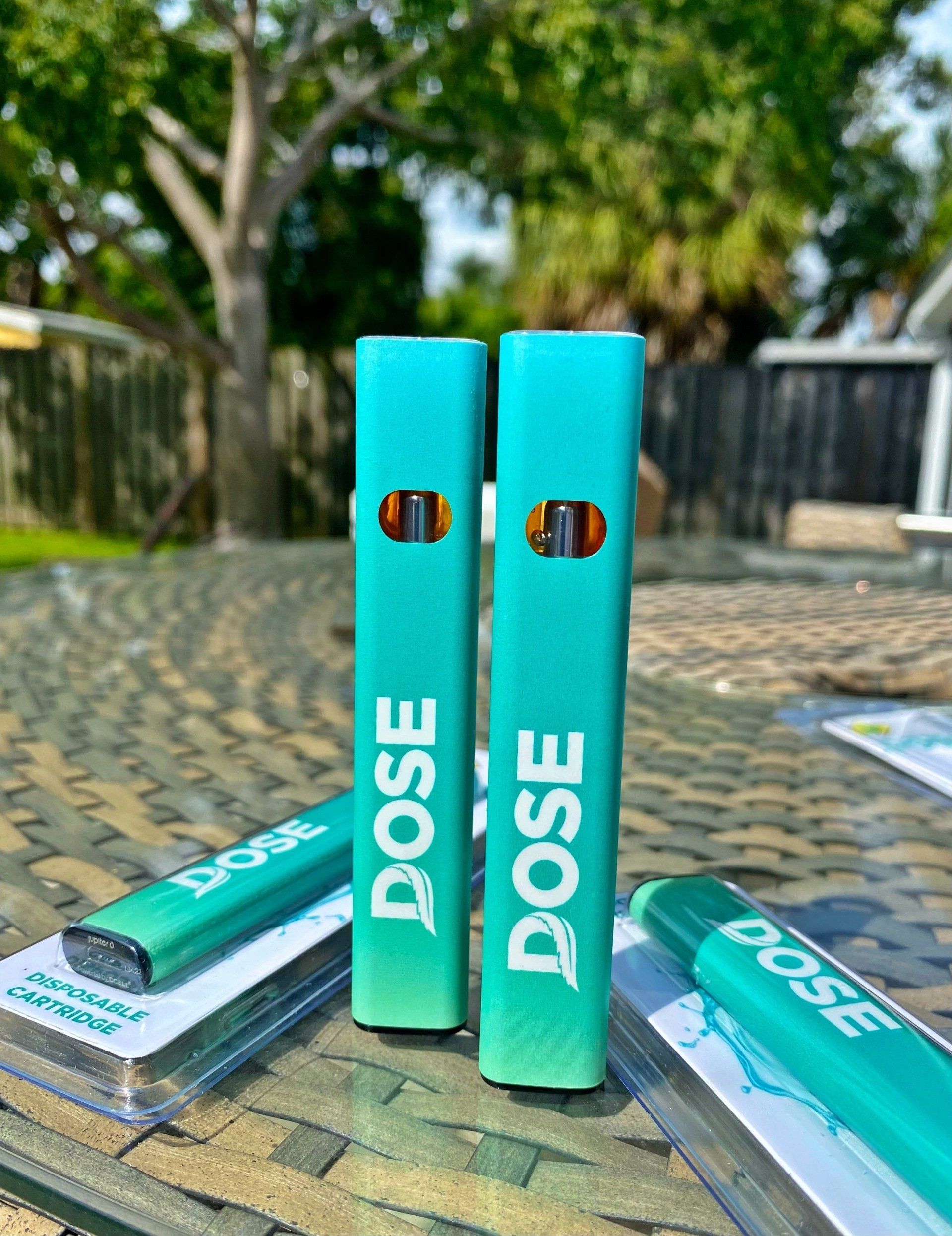 Two dose electronic cigarettes are sitting on a table.