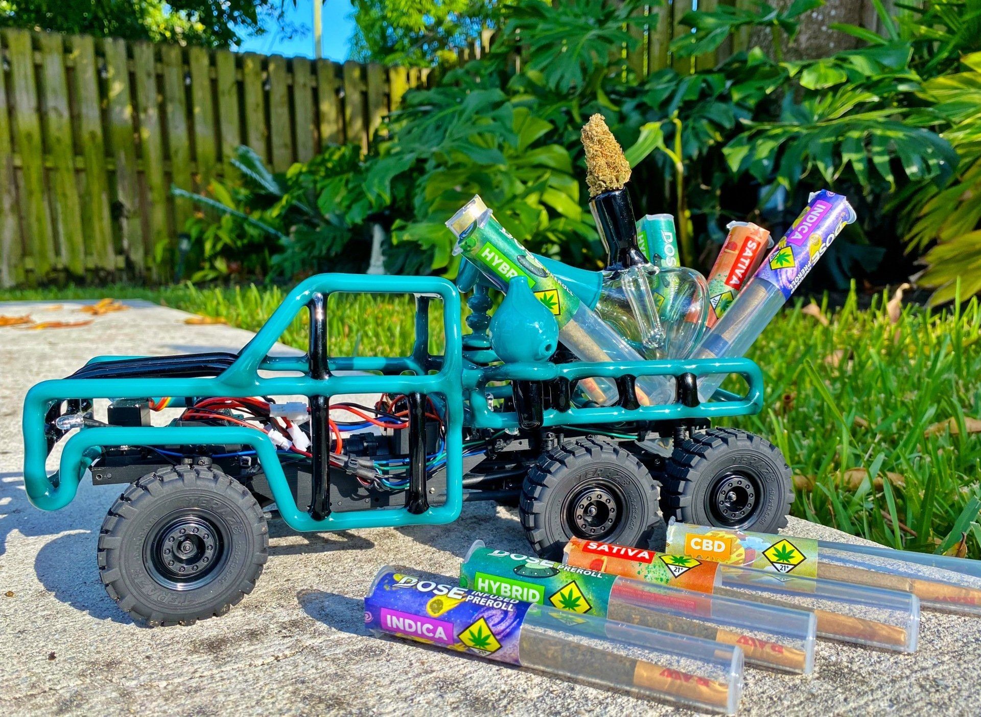 A toy truck with a bunch of pipes in it is sitting on the ground.