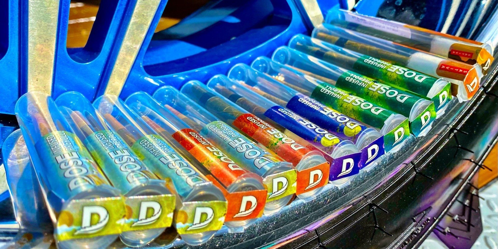 A bunch of tubes of candy are lined up on a table.