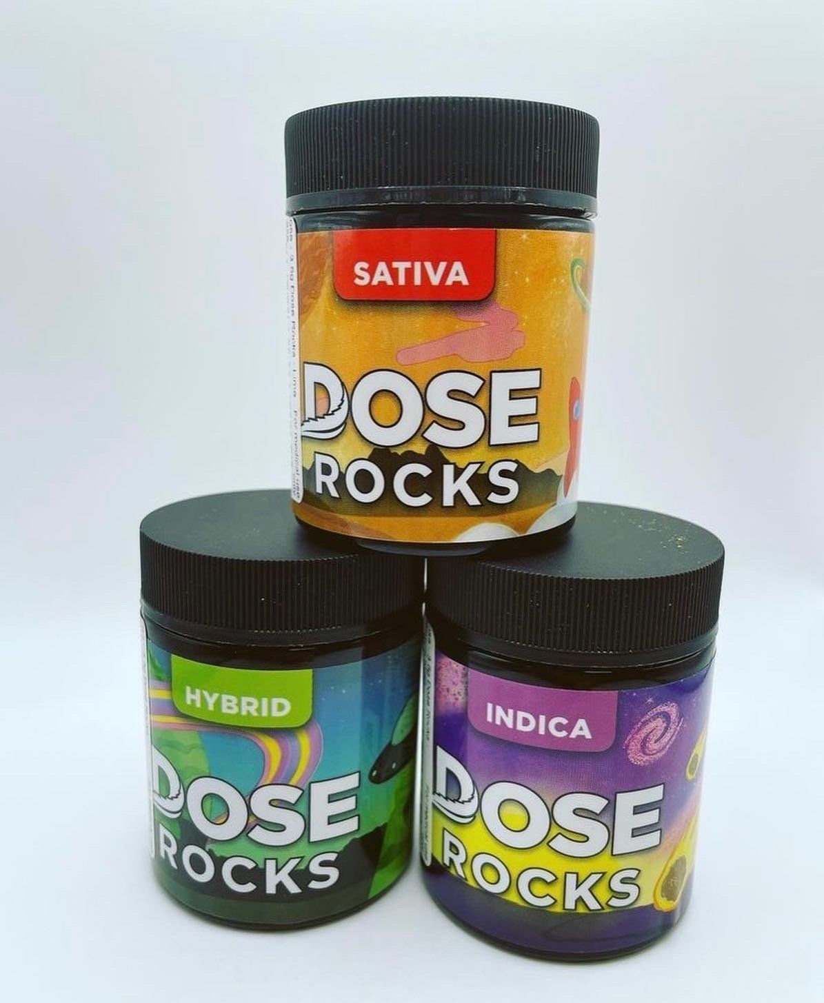 Three jars of dose rocks are stacked on top of each other on a white surface.