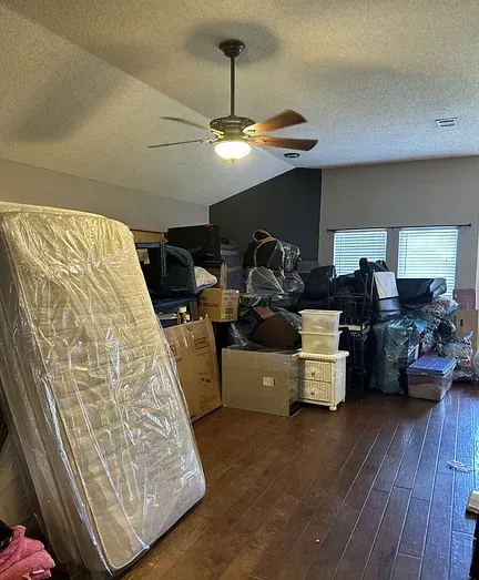 A room filled with lots of furniture and a ceiling fan.