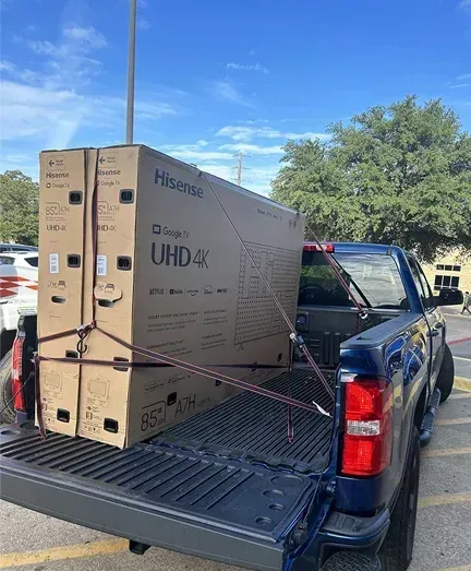A large box is sitting in the back of a truck.