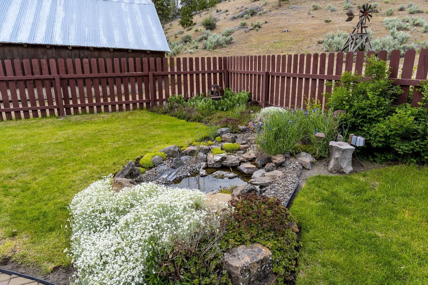 There is a pond in the middle of the yard.