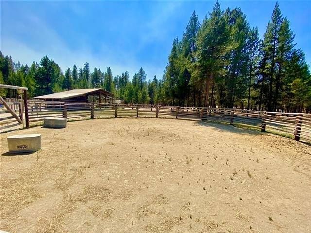 A fenced in area with trees in the background