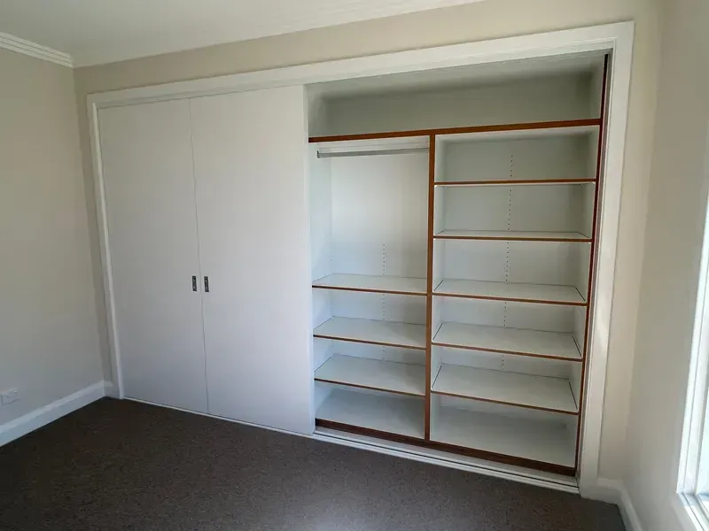 Closet With White Sliding Doors Open  — JRB Joinery In Kew, NSW