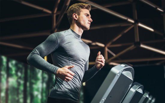 Man Using the Treadmill — Brick, NJ — Ocean Fitness Equipment Man Using the Treadmill — Brick, NJ — Ocean Fitness Equipment