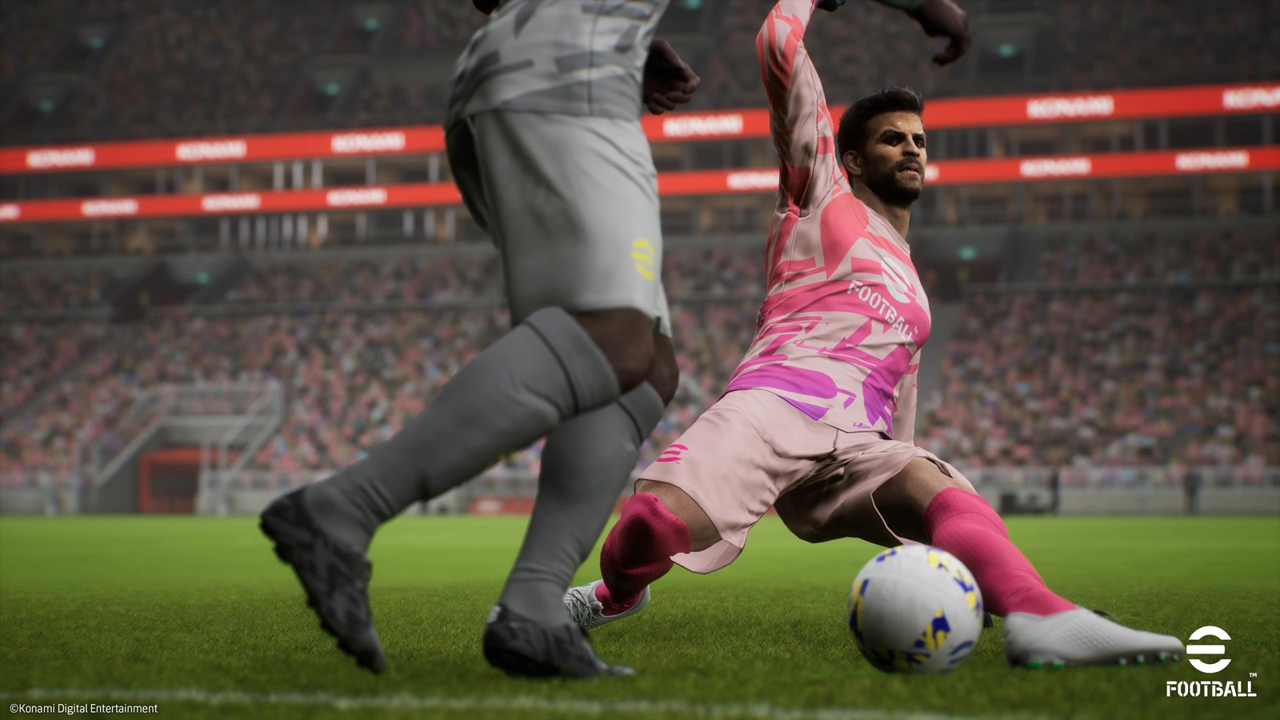Two soccer players are playing a game of soccer on a field.
