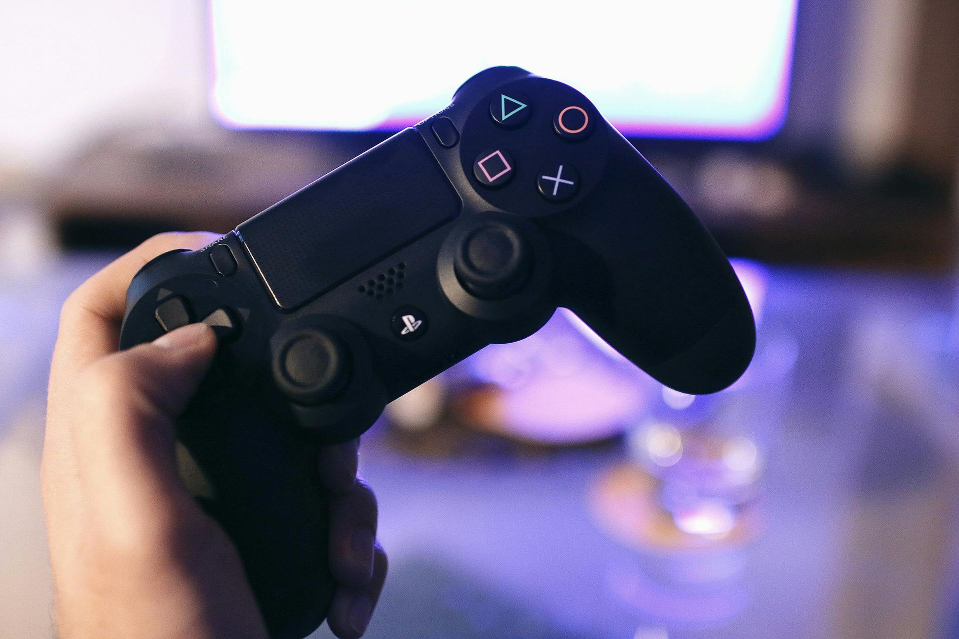 A person is holding a video game controller in their hand.