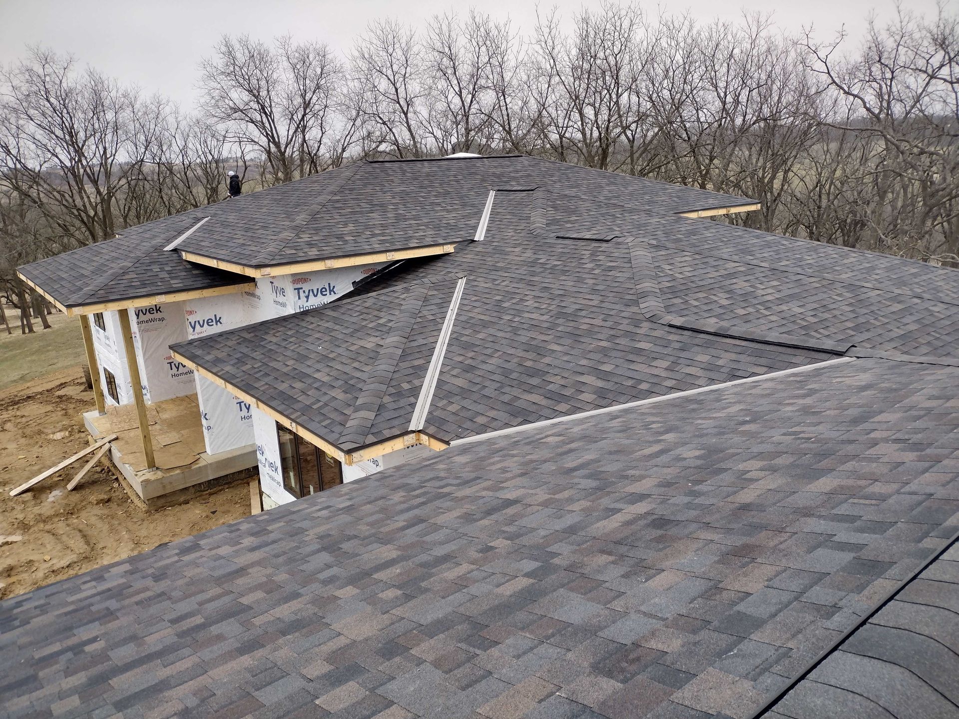 Skilled worker hands carefully arranging and securing roof tiles, creating a durable and precise roofing structure.