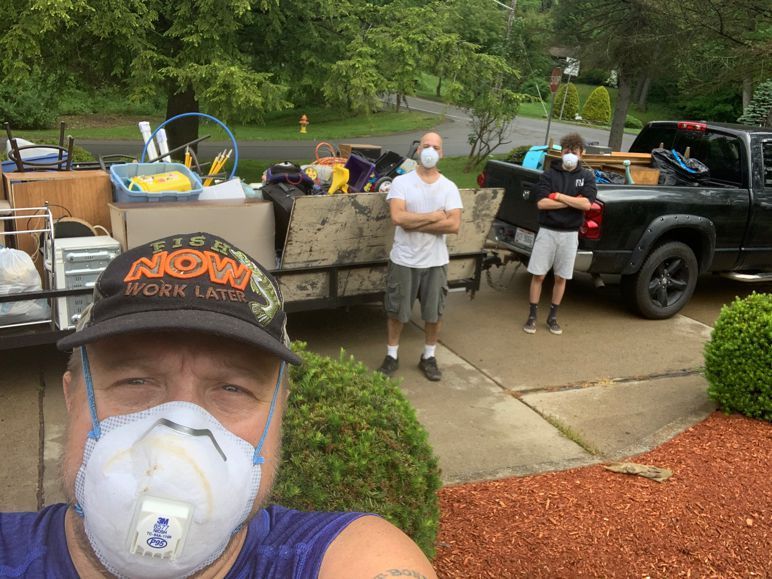 a man wearing a mask is standing in front of a truck .