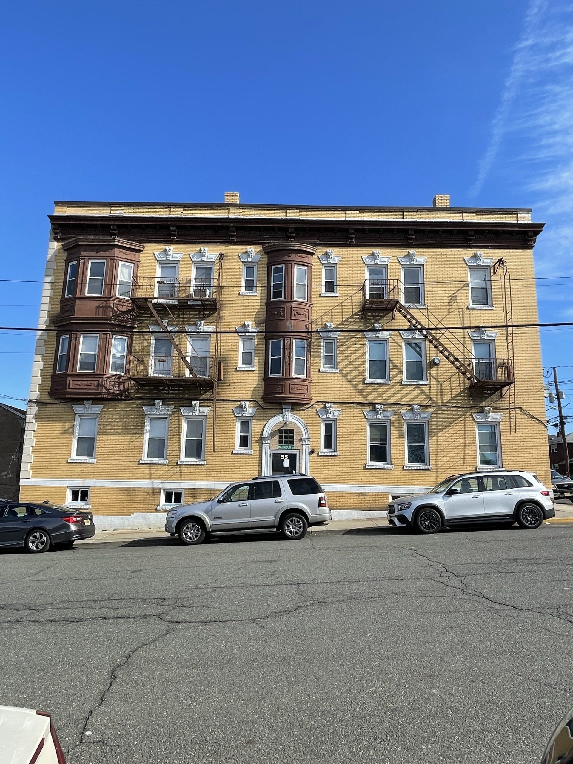 Exterior of 55 Harrsion Ave, Garfield, NJ - 6 Unit. Brick three-story building.