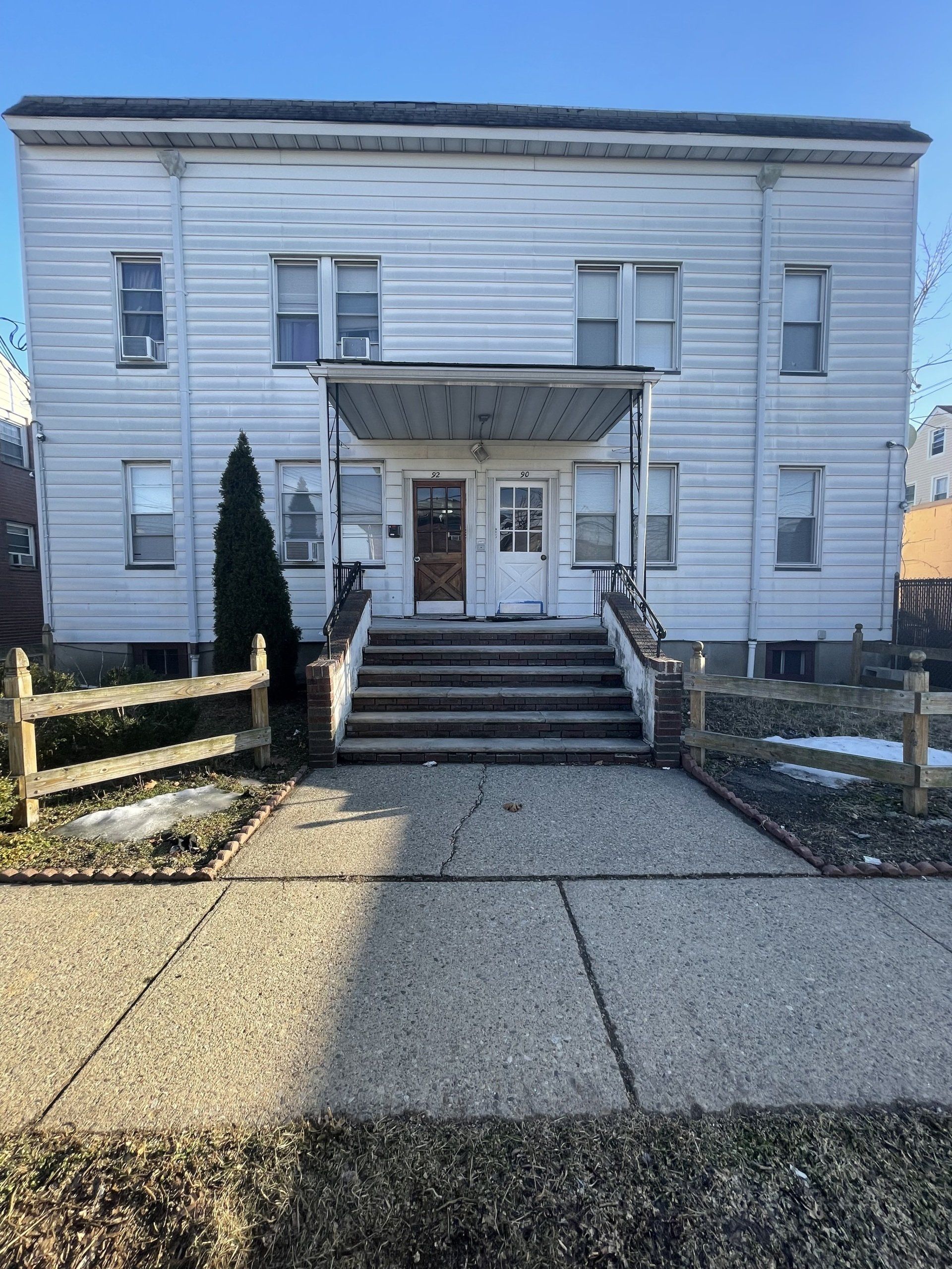 Exterior of 9092 Maple St. Garfield, NJ - 4 Unit. White two-story building.