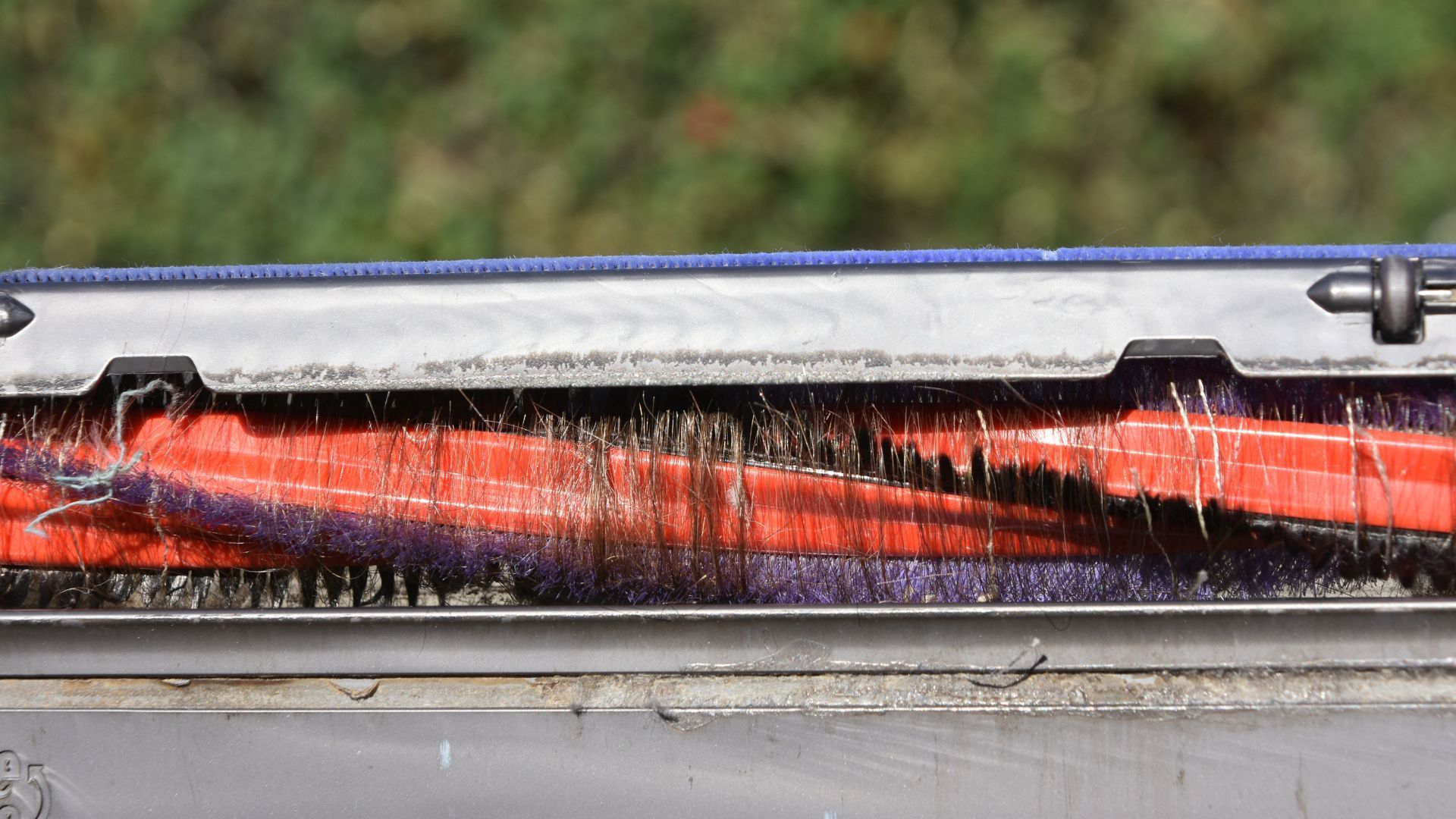 A close up of a brush on a vacuum cleaner.