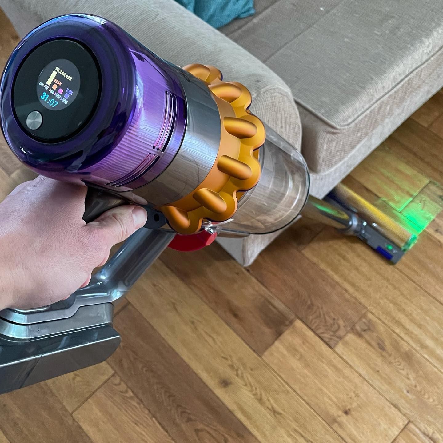 A person is using a vacuum cleaner in a living room