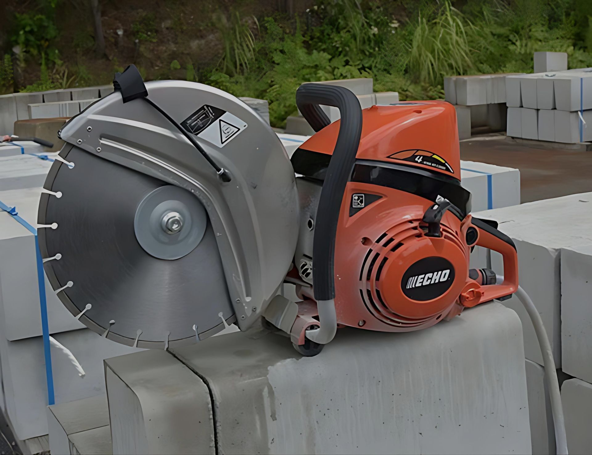 An Echo Chainsaw is Sitting on Top of a Concrete Block — Diamond Service Centre In Lismore, NSW