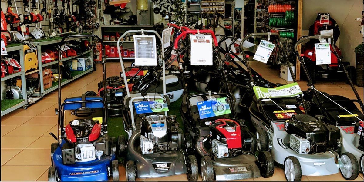 A Row of Lawn Mowers Are Lined Up in a Store — Diamond Service Centre In Lismore, NSW