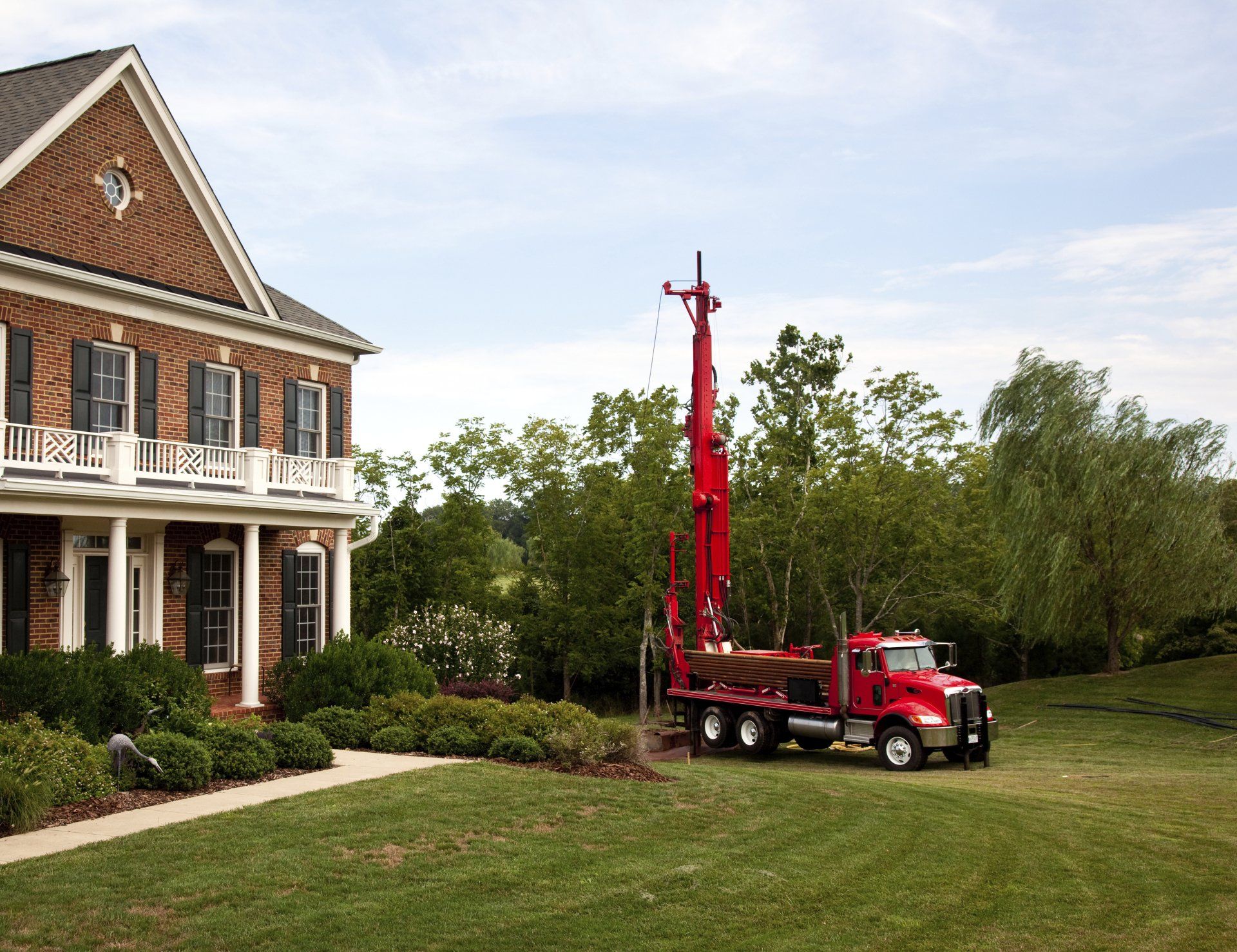 Red Truck Drilling In Yard — Rochester, WA — Advanced Drilling
