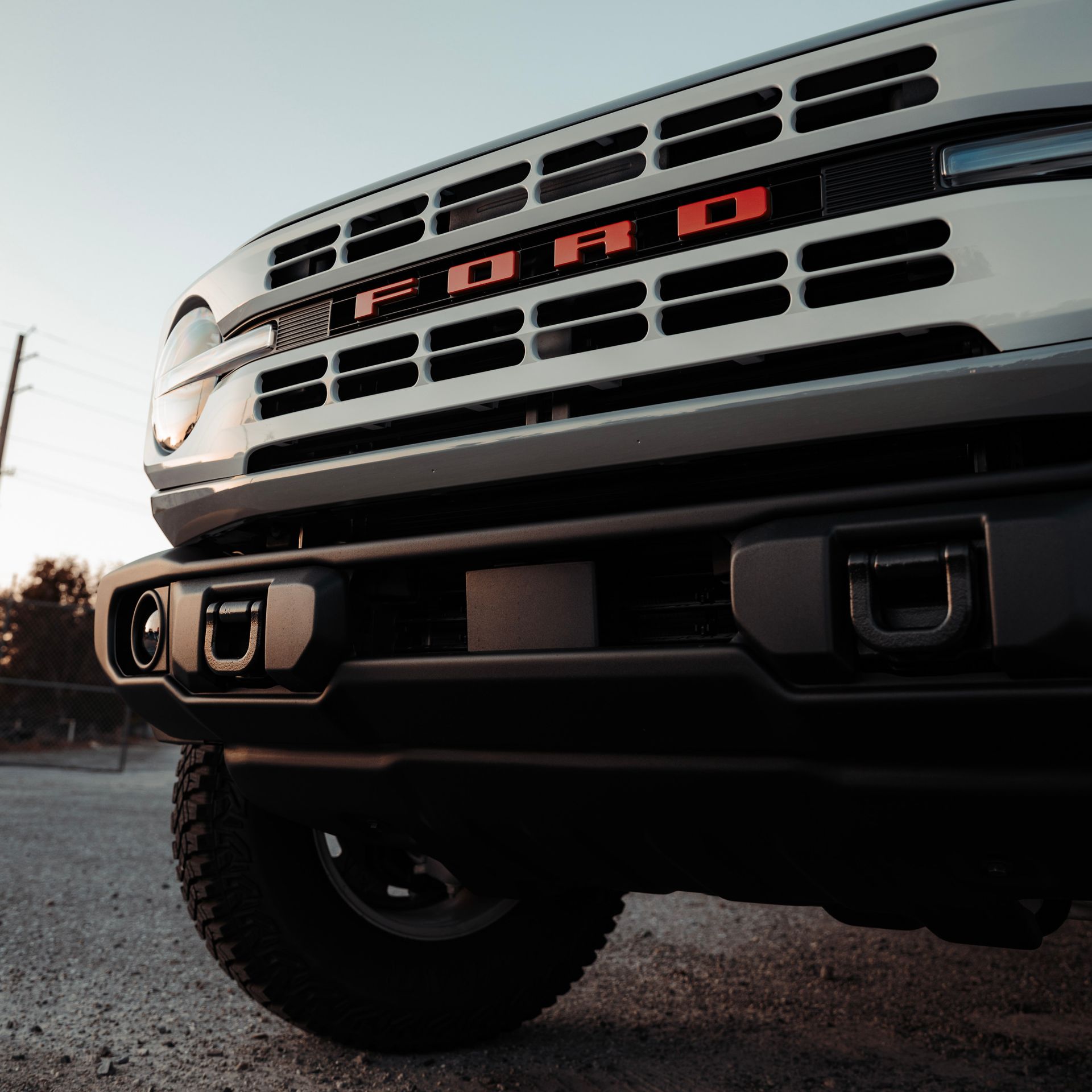 Close-up of a white Ford Bronco front, black bumper with tow hooks, 