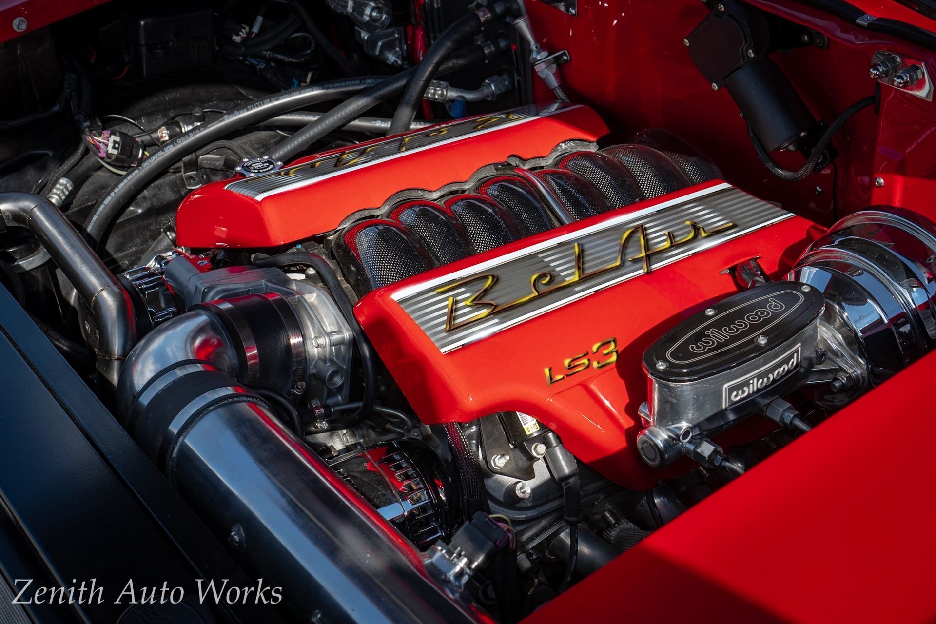Bright red engine with chrome accents in an automobile. 