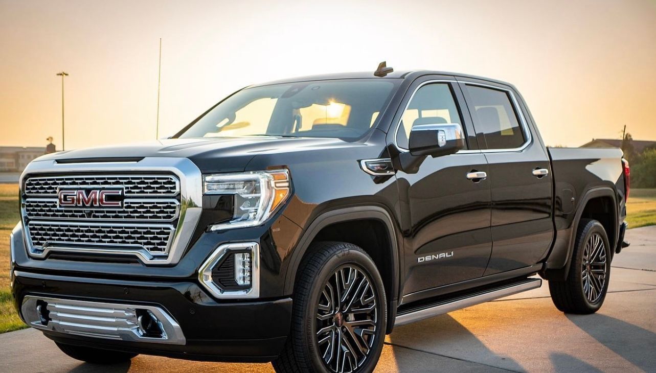 Black GMC Sierra truck parked at sunset.