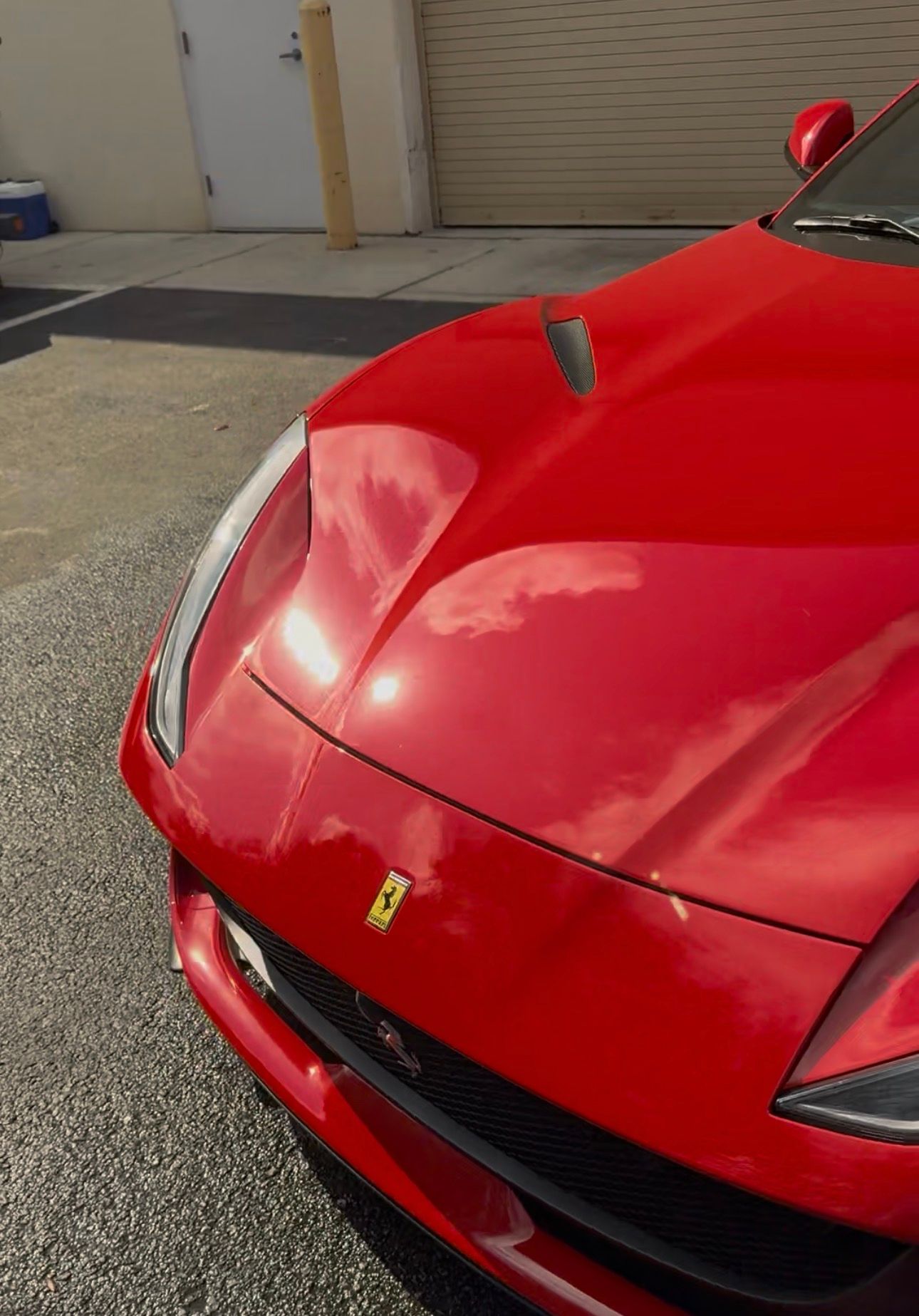 Red Ferrari sports car parked outdoors.