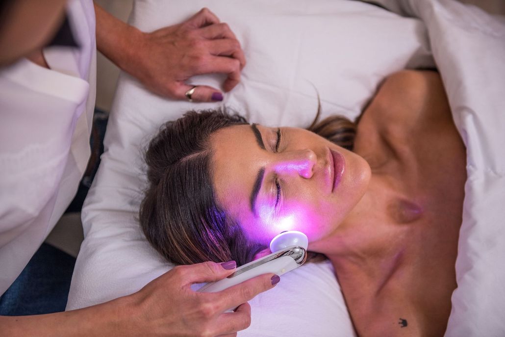 A woman is getting a facial treatment at a spa.