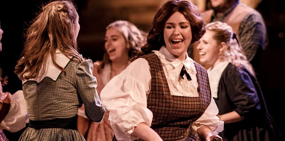 A group of young women are dancing on a stage.