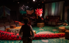 A man is standing in front of a large red snake on a stage.