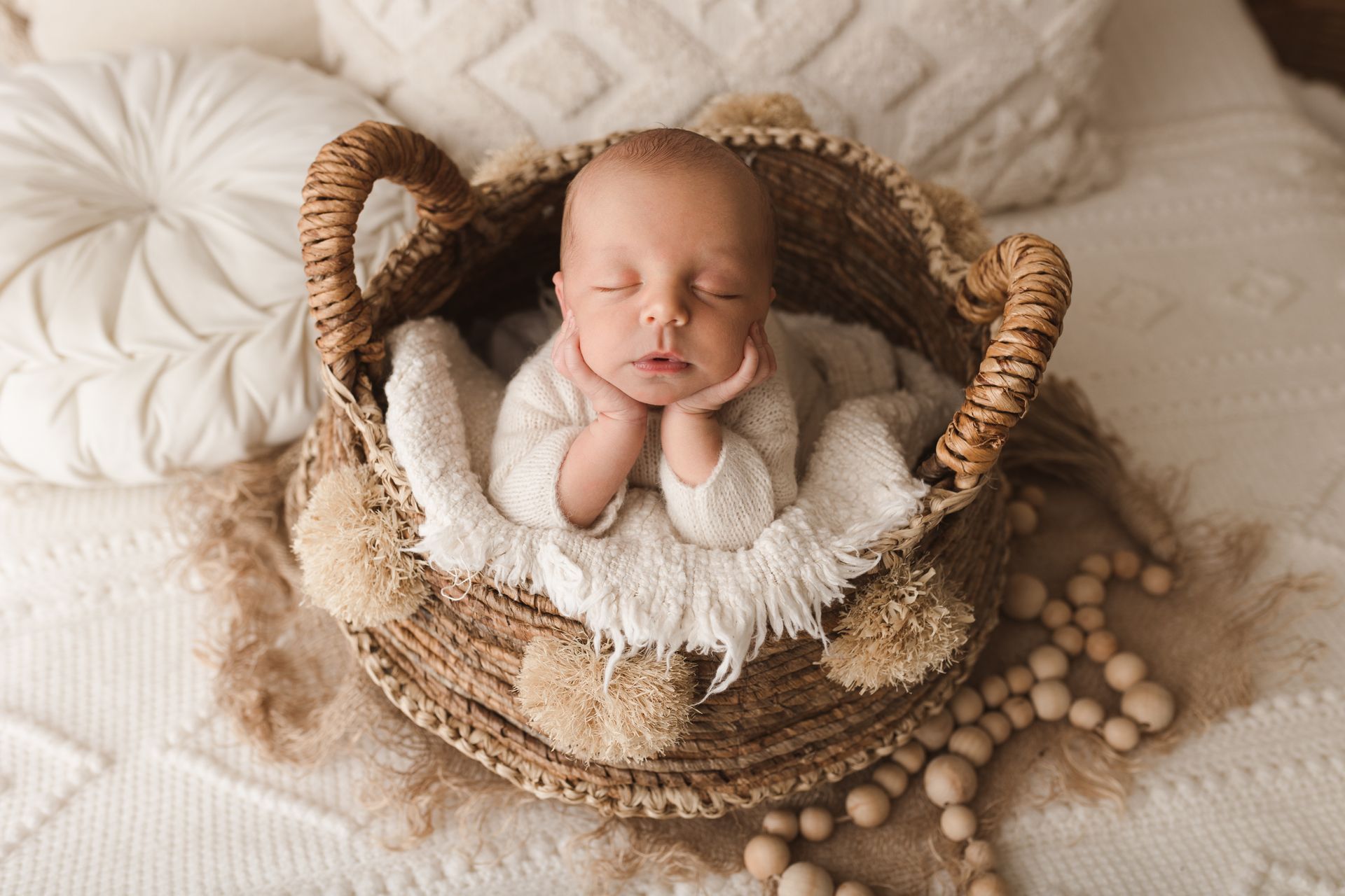 A baby with balloons in the background.