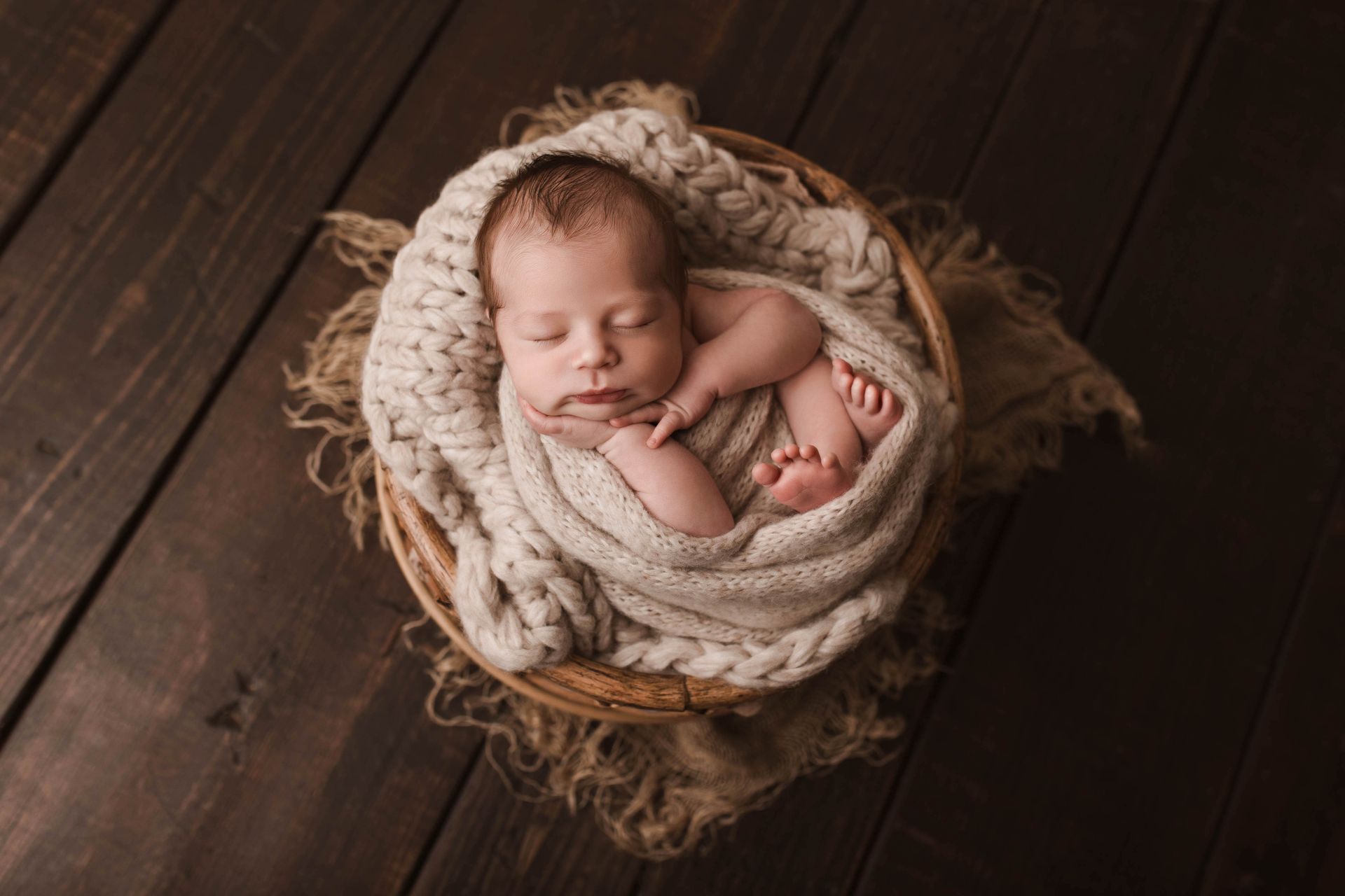 A woman is holding a newborn baby in her arms.