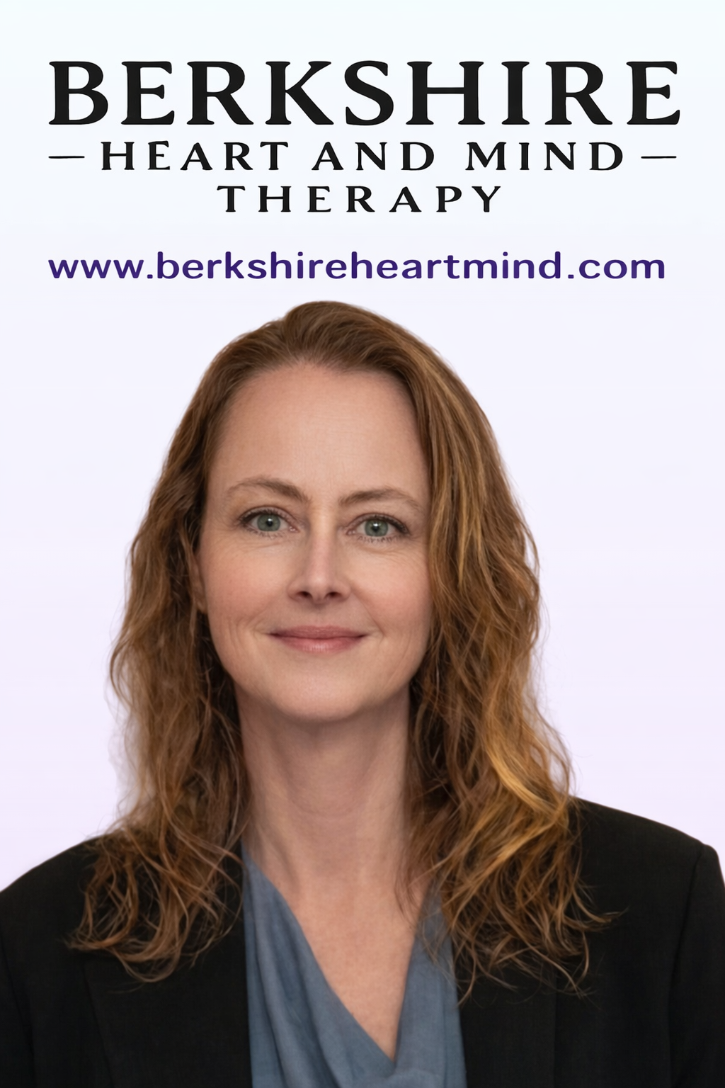 A woman in a blue shirt and black jacket is standing in front of a light purple background with the company name Berkshire Heart and Mind Therapy behind her.